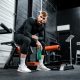 woman in black long sleeve shirt and black pants sitting on exercise equipment