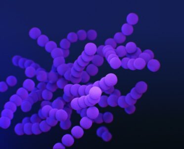 a bunch of purple balls are in the air